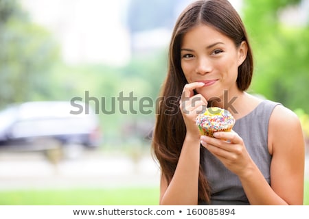 Beautiful Young Woman Eating Cupcake Stock foto © Maridav