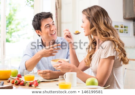 Stockfoto: Fun Couple Eating Breakfast Cereal
