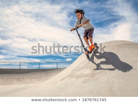 Stock photo: Young Boy Going Airborne With Scooter
