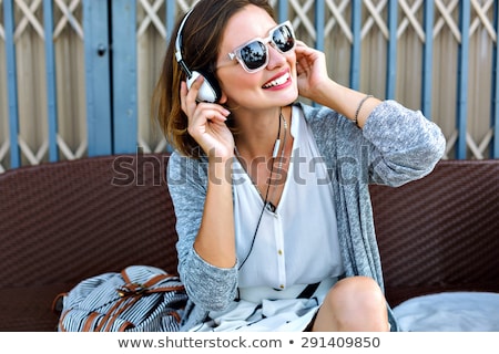 ストックフォト: Girl Listens To Music At The Beach