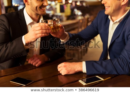 ストックフォト: Smiling Happy Businessman In Suit Holding Glass Of Whiskey