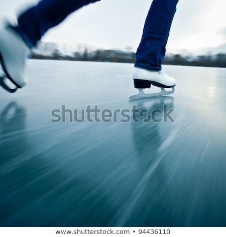 Foto d'archivio: Young Woman Ice Skating Outdoors On A Pond