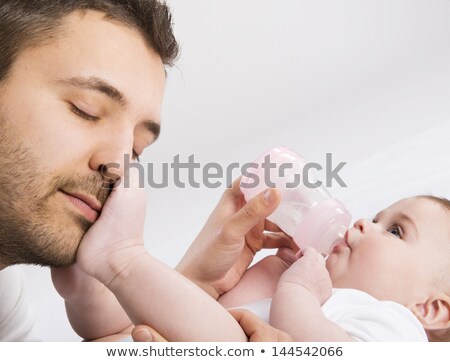 Stock photo: Young Father Enjoying His Baby Feeding