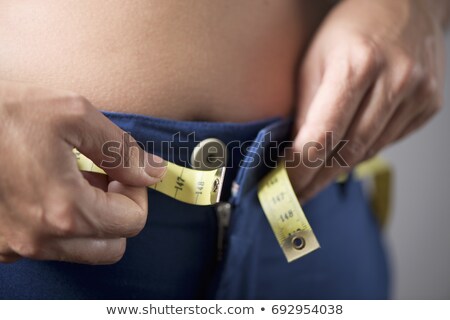 Mujer con sobrepeso tratando de abrocharse los pantalones Foto stock © nito
