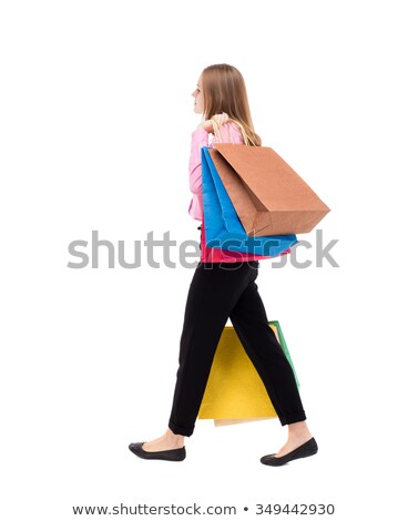 Stok fotoğraf: Side View Of A Walking Businessman Looking Back Over Shoulder