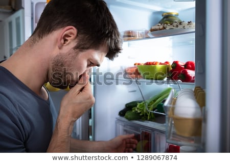 Foto stock: Man Recognizing Bad Smell From The Refrigerator