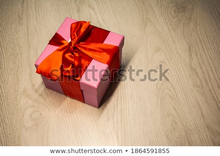 Stok fotoğraf: Three Colored Gift Boxes With Bows On A Gray Wooden Background