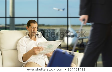 Stok fotoğraf: A Man In The Lounge Area At The Airport Is Waiting For His Plane