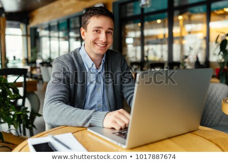 [[stock_photo]]: Smiling Businessman Looking At Camera In Restaurant