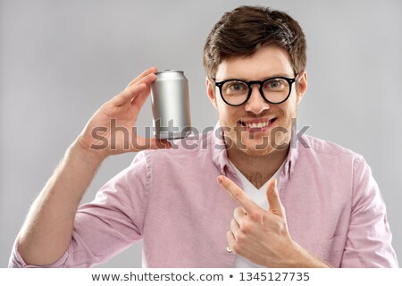 Stockfoto: Happy Young Man Drinking Soda From Tin Can