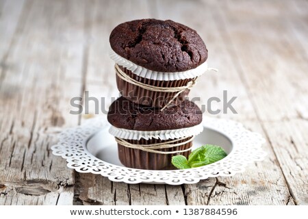 Stok fotoğraf: Two Fresh Dark Chocolate Muffins With Mint Leaves On White Plate