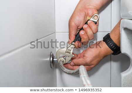 Zdjęcia stock: Plumber With An Adjustable Wrench