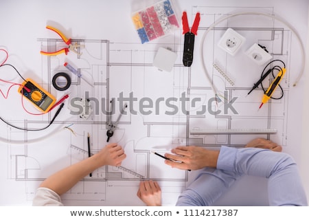 Foto d'archivio: A Female Electrician Holding A Voltmeter