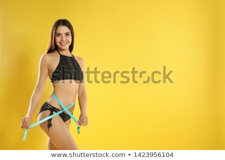 Stock fotó: Portrait Of Happy Young In Bikini Measuring Waist