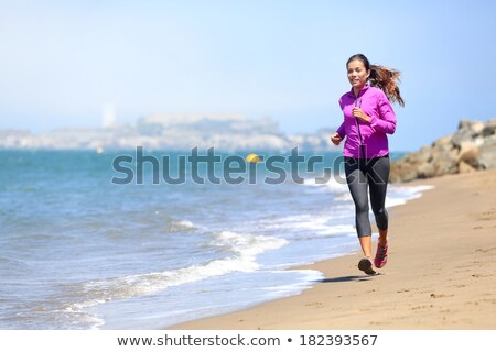 Foto stock: Woman Running On San Francisco Beach