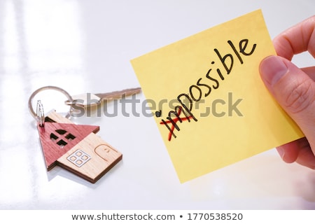 Stock photo: Hand With Help On Yellow Note