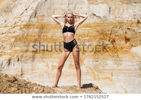 Stock fotó: Blonde Girl In Yellow Bikini Posing