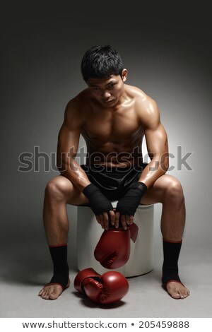 Stockfoto: Exhausted Man Boxer Sitting On Ring And Thinking