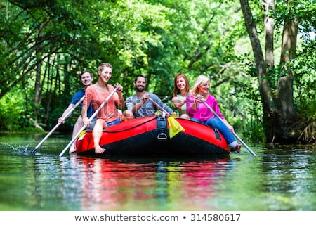 Group Of People In Rubber Dinghy Foto stock © Kzenon