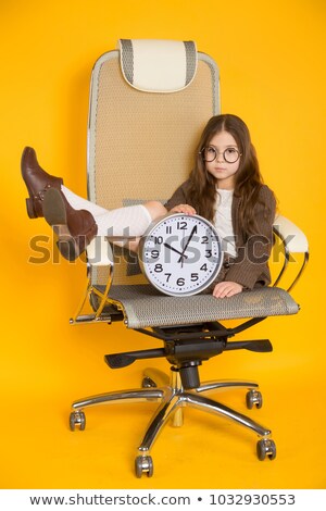 ストックフォト: Little Brunette Girl With Clocks In Chair