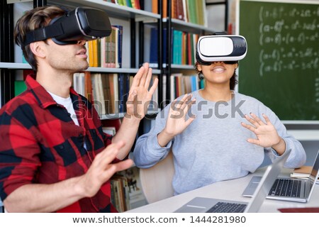 Zdjęcia stock: Young Astonished Man And Woman In Vr Headsets Having Virtual Experience