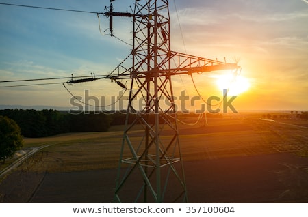 Foto stock: Transmission Tower And Power Line Over Blue Sky