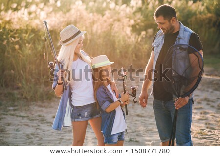 Foto d'archivio: Fishermen Go Fishing With Fishing Rods In Their Hands