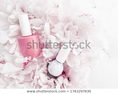 Foto d'archivio: Nail Polish Bottles On Floral Background French Manicure And Cosmetic Branding