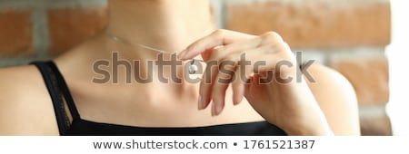 Foto stock: Portrait Of Young Sitting Young Woman Wearing Red Dress