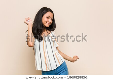 Сток-фото: Portrait Of A Delighted Woman Listening To Music Against A White Background