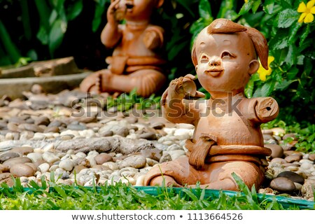 Stok fotoğraf: Happy Clay Doll Used In Ornamental Garden