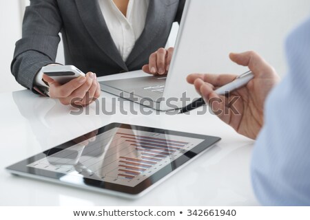 Zdjęcia stock: Two Businessmen Using Laptop And Tablet In Office Together