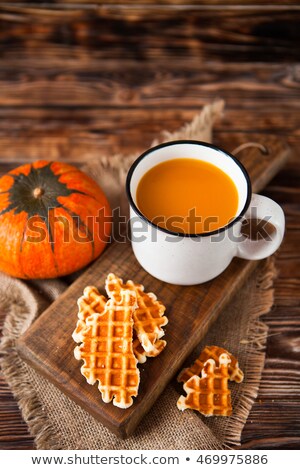 ストックフォト: Mug Of Fresh Pumpkin Juice With Wafer And Pumpkin On Dark Wooden