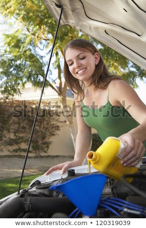 Stock fotó: Young Caucasian Woman Fills Car Motor With Oil