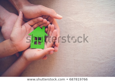 Stockfoto: Hands Holding Green Paper House