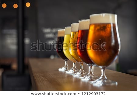 Stok fotoğraf: Alcoholic Drinking Beer From Glass At Night