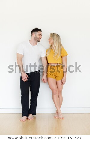 Stock photo: Full Length Portait Of Cheerful Couple Smiling And Looking On Y