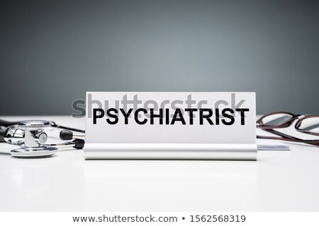 Zdjęcia stock: Nameplate With Psychiatrist Job Title Against Grey Background