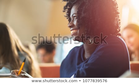Stock photo: Student Girl Writing To Notebook In Lecture Hall