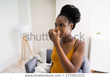 Foto d'archivio: African Woman Feeling Bad Air Smell Or Odor