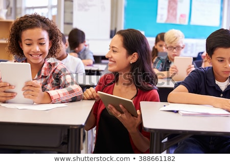 Zdjęcia stock: Group Of Elementary Pupils In Computer Class With Teacher