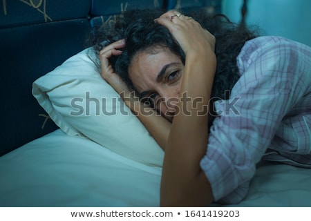 Stock foto: A Middle Eastern Woman Lying On A Bed