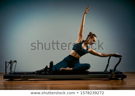 Foto stock: Gym Woman Pilates Stretching Sport In Reformer Bed