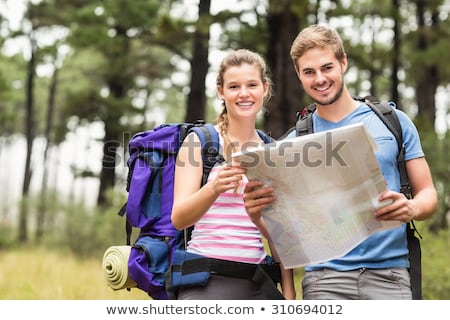 Foto d'archivio: Smiling Couple With Backpacks In Nature