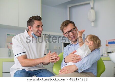 ストックフォト: Father And Son Visiting Dentist At Dental Clinic
