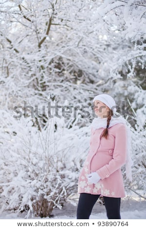 Stockfoto: Young Happy Pregnant Woman In Snowy Forest