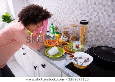 ストックフォト: Tired Woman Leaning Near Sink With Dirty Utensils