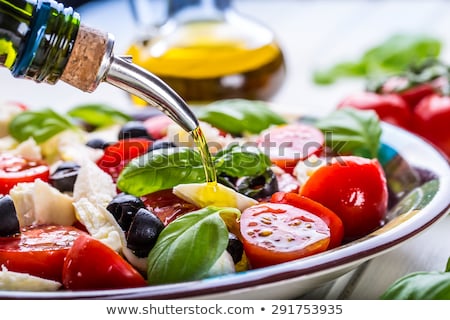 Foto d'archivio: Italian Caprese Salad With Sliced Tomatoes Mozzarella Cheese Basil Olive Oil