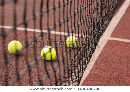 Stok fotoğraf: Three Balls For Playing Tennis On Playground Behind Net