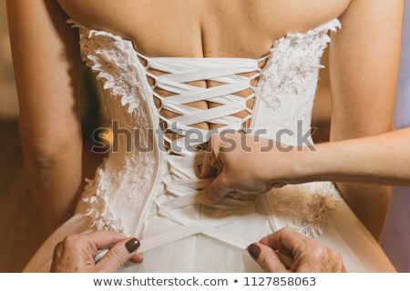 Foto stock: Lacing In Back Of Fashion Corset On Young Model